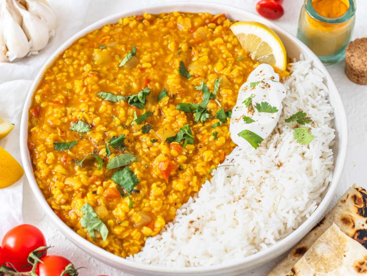 Moong dal served with basmati rice, yogurt, and fresh cilantro.