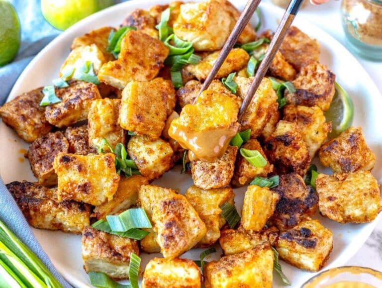 Pan-fried tofu dipped in peanut sauce.