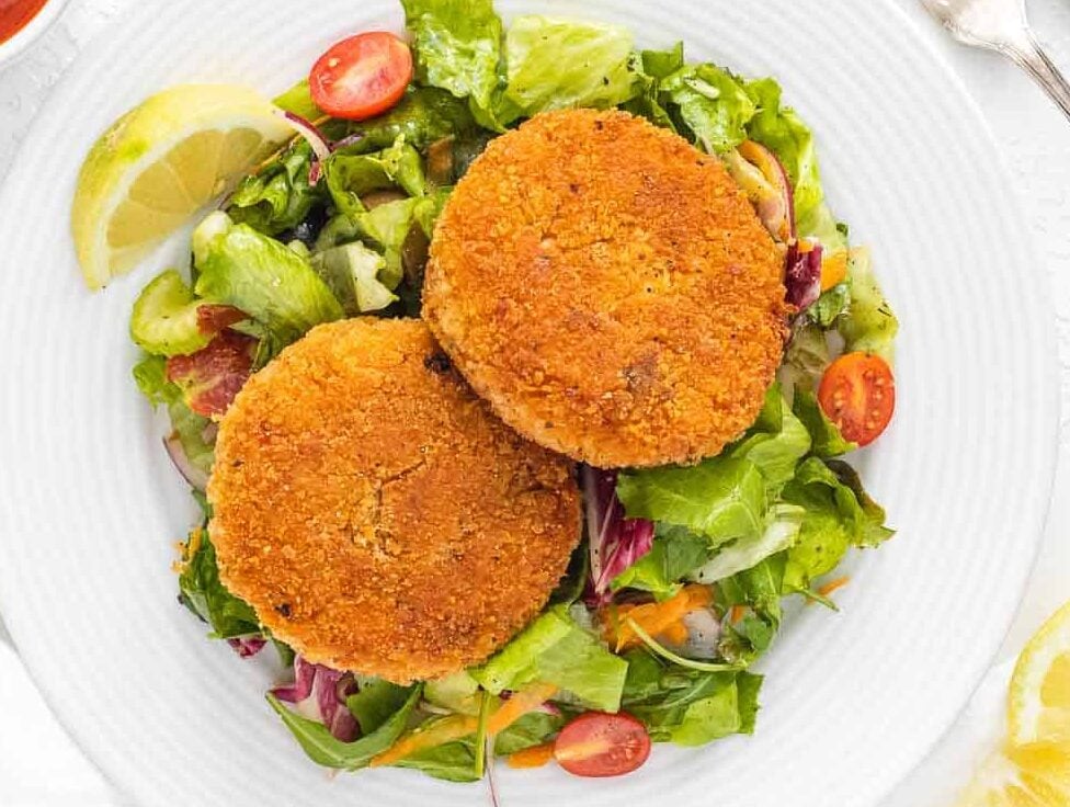 risotto cakes on side salad served with marinara sauce