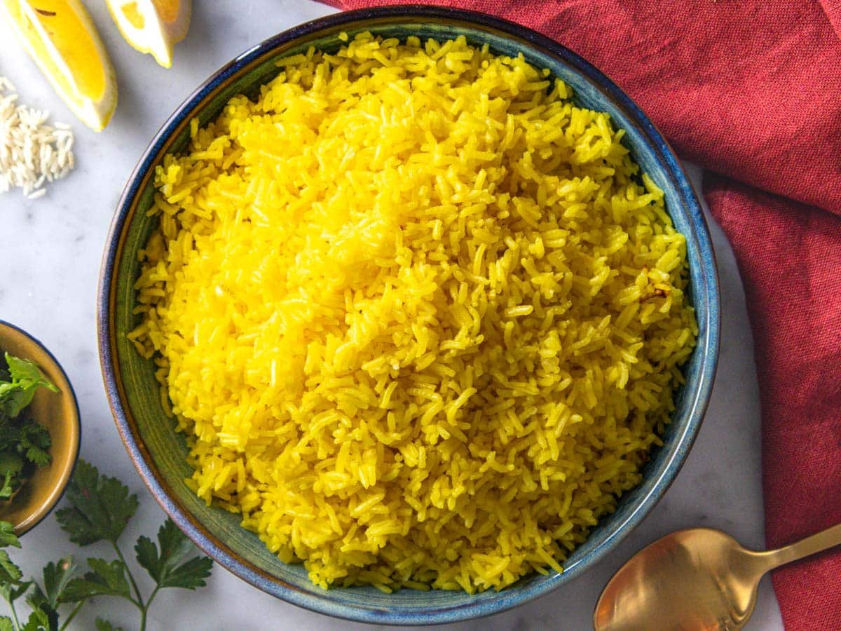 Saffron rice on a blue plate.
