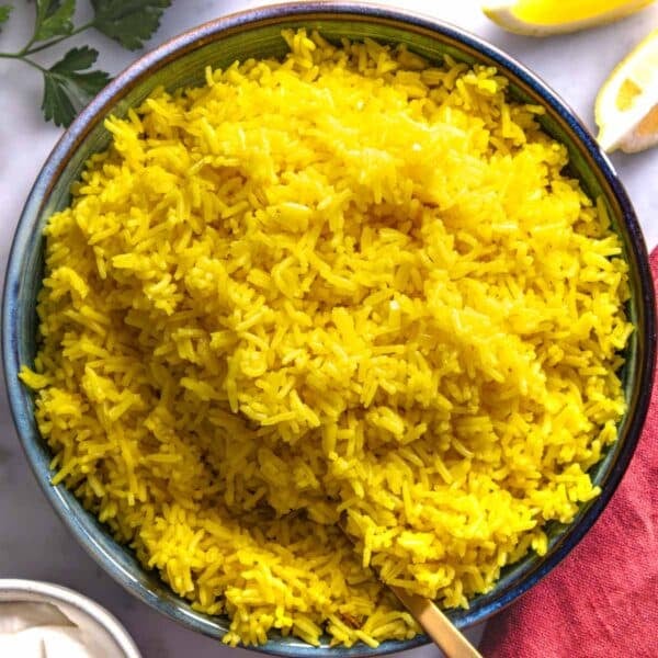 Saffron rice in a blue bowl.