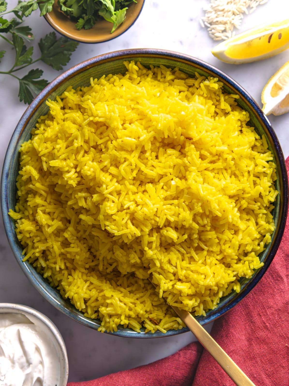 Saffron rice in a blue bowl.