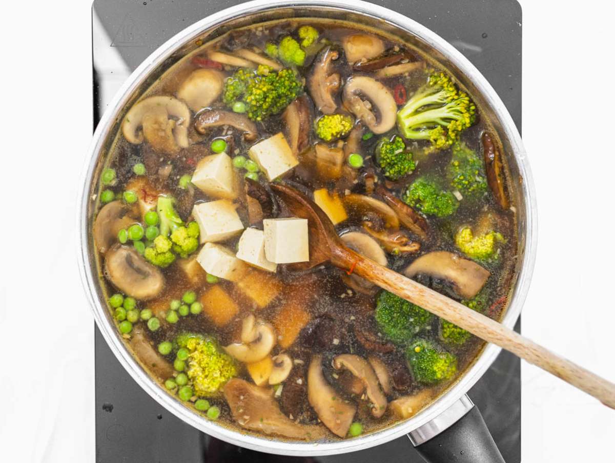 Step 2 Tofu broccoli peas and broth simmering together for easy one pot tofu soup.