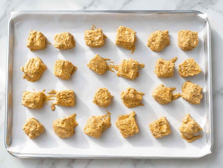 Step 3 Hand-torn marinated tofu coated evenly before arranging on baking sheet.