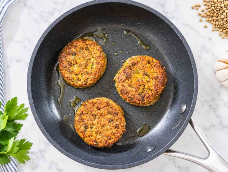 Step 3 Lentil patties cooking in a skillet until deeply golden and crisp around the edges.