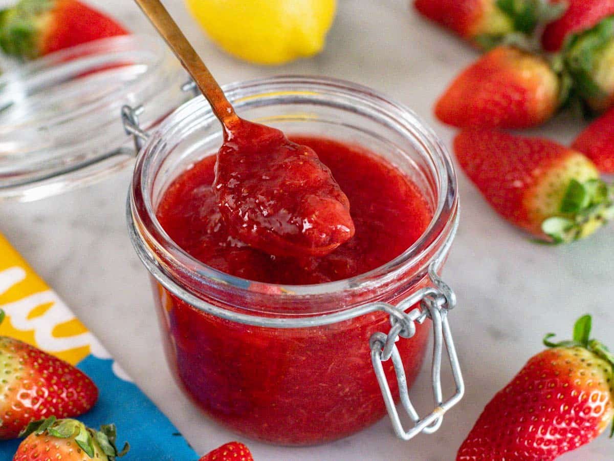 Homemade strawberry jam in a glass jar.