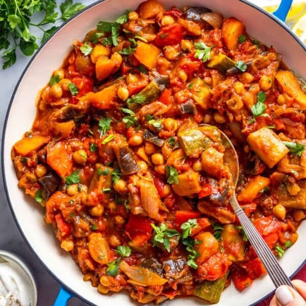 Tagine in a blue skillet with a silver spoon.