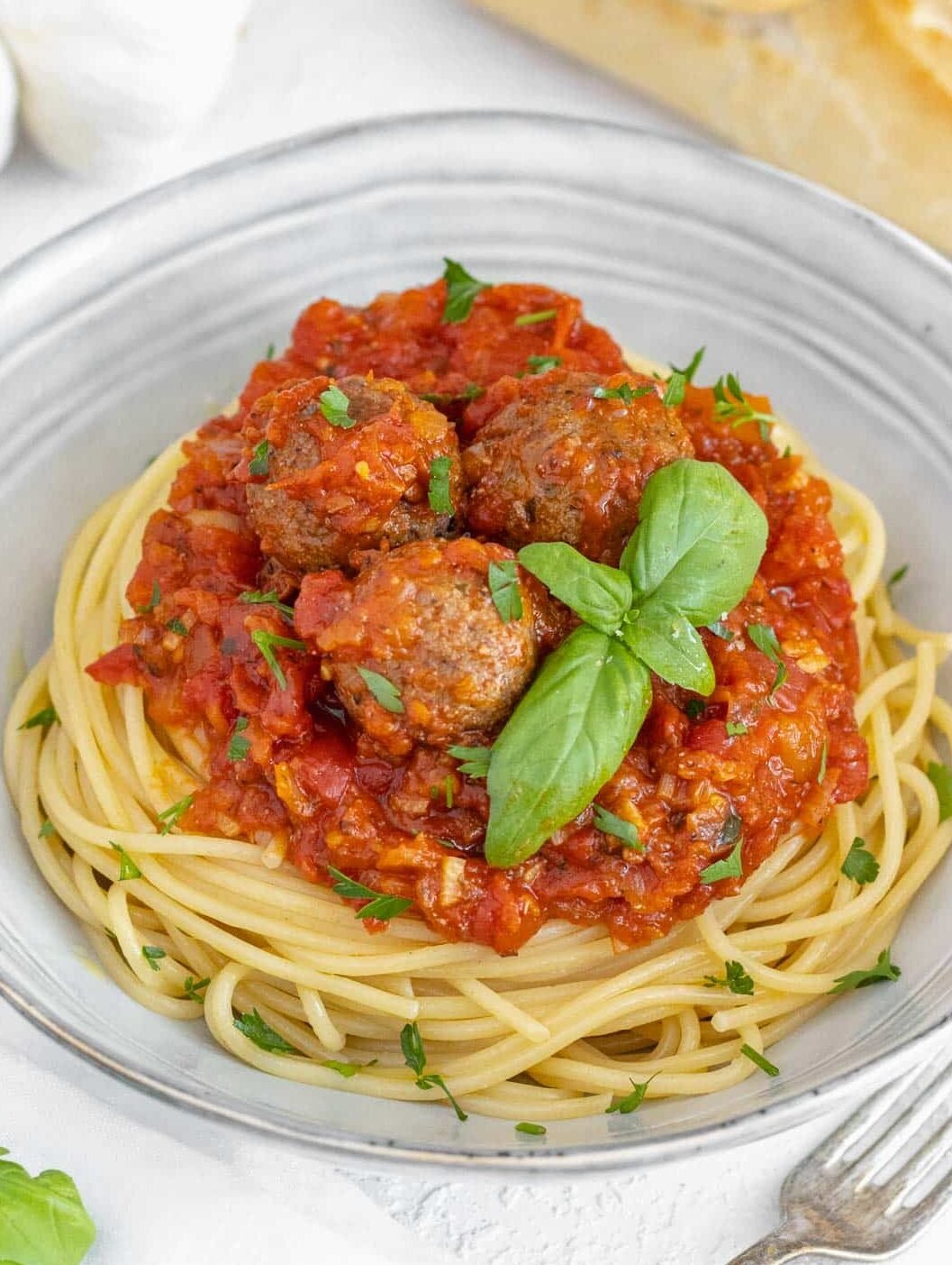 Tofu meatballs with spaghetti in a bowl.
