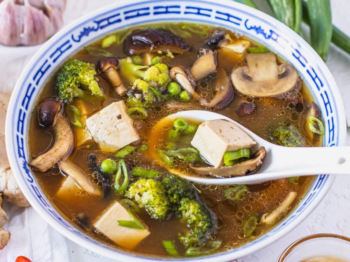 Tofu soup with frozen peas and mushrooms