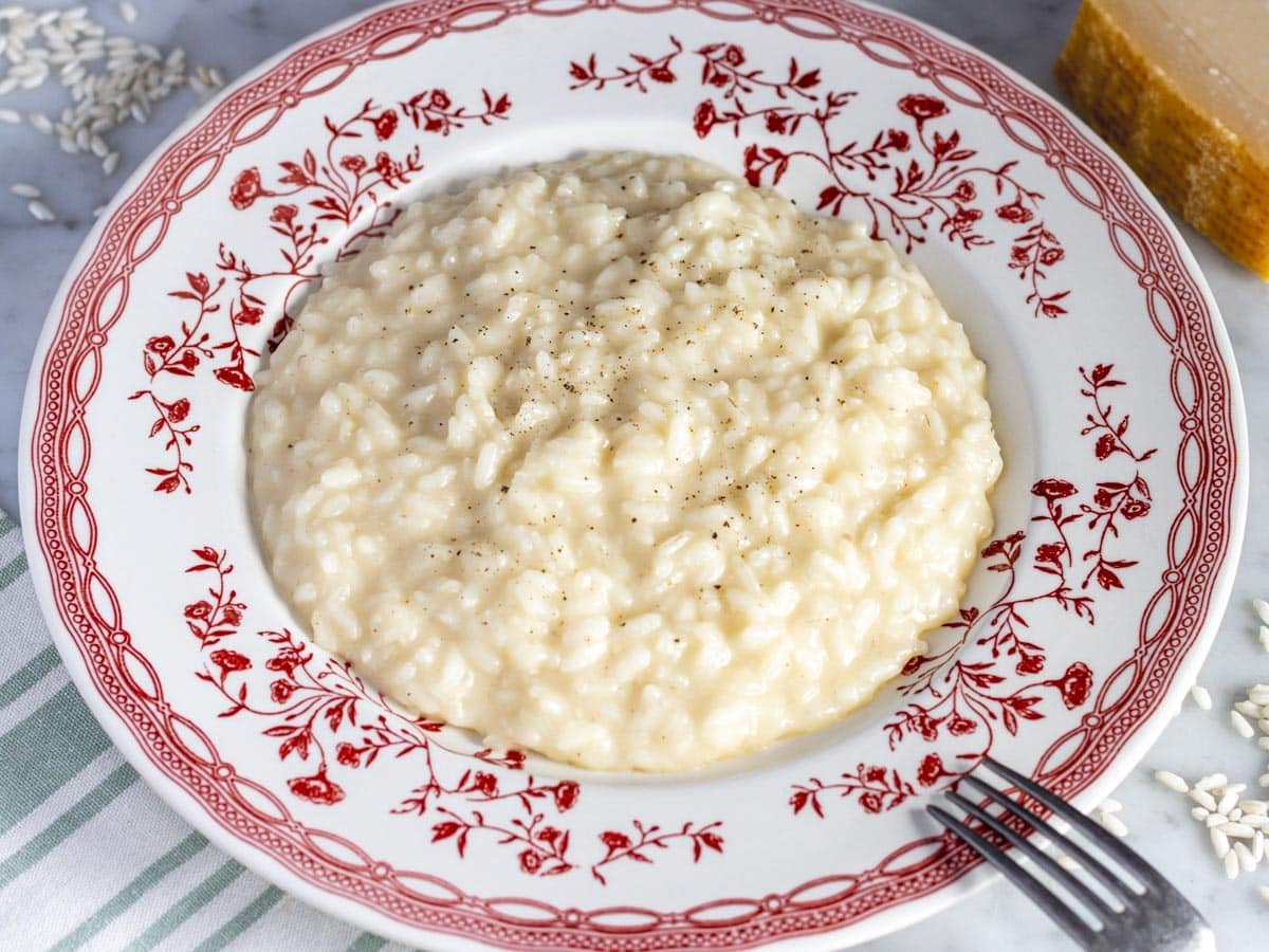 Creamy parmesan risotto on a flat plate.