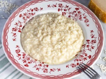 Creamy parmesan risotto on a flat plate.