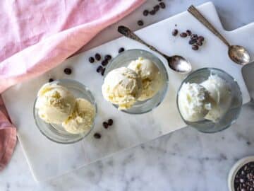 Scoops of vanilla ice cream in glasses.