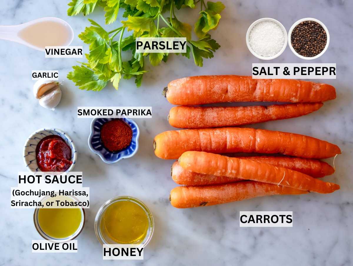 Ingredients for Roasted Carrots on a marble table.
