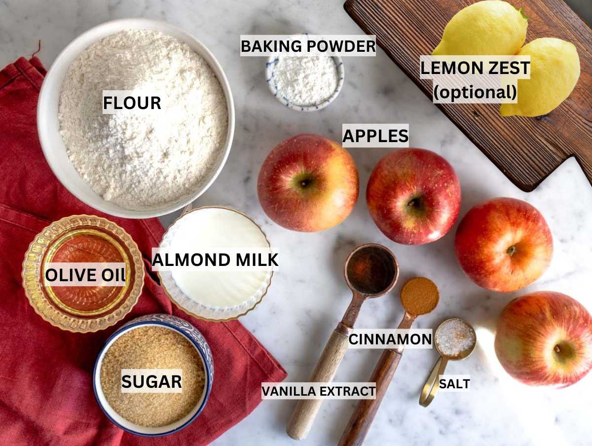 Ingredients for vegan apple cake on a marble table.