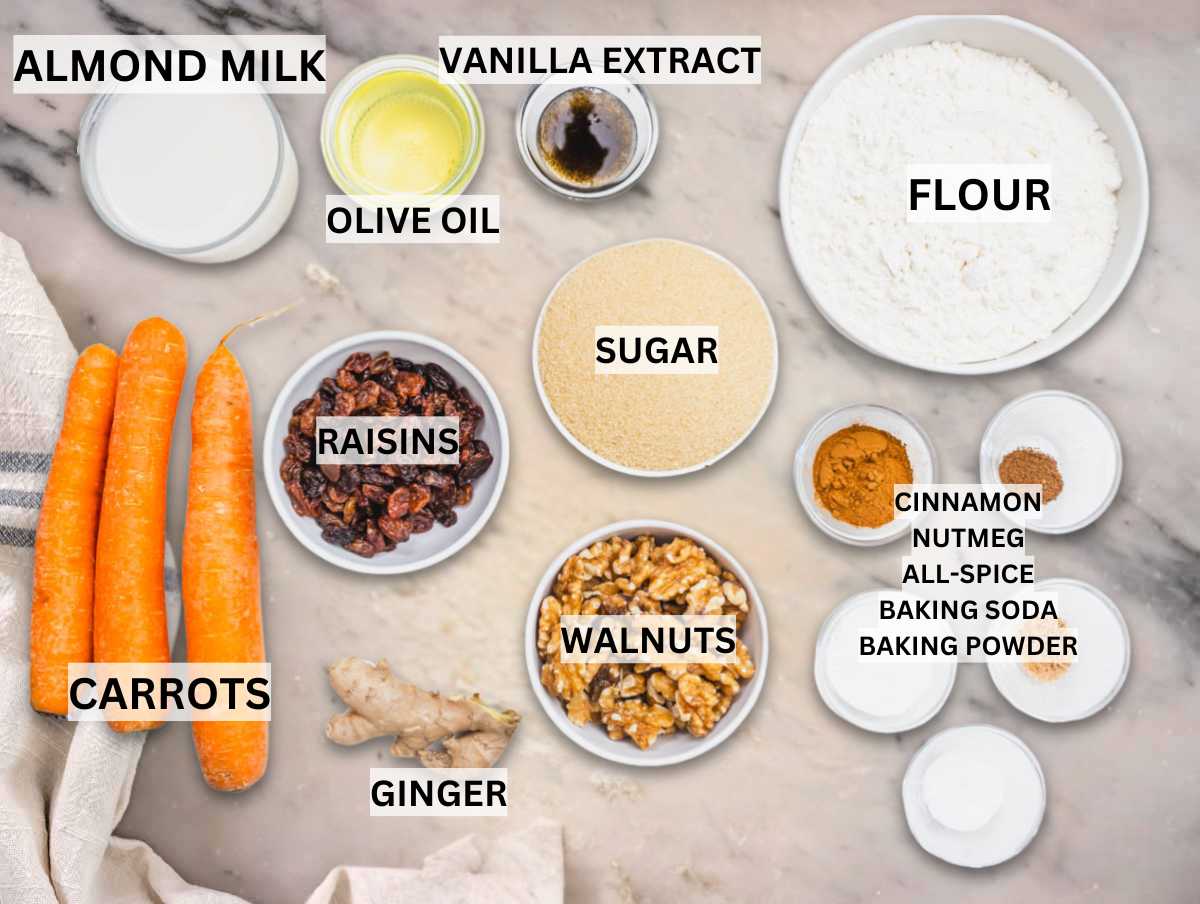 Ingredients for vegan carrot cake on a marble table.