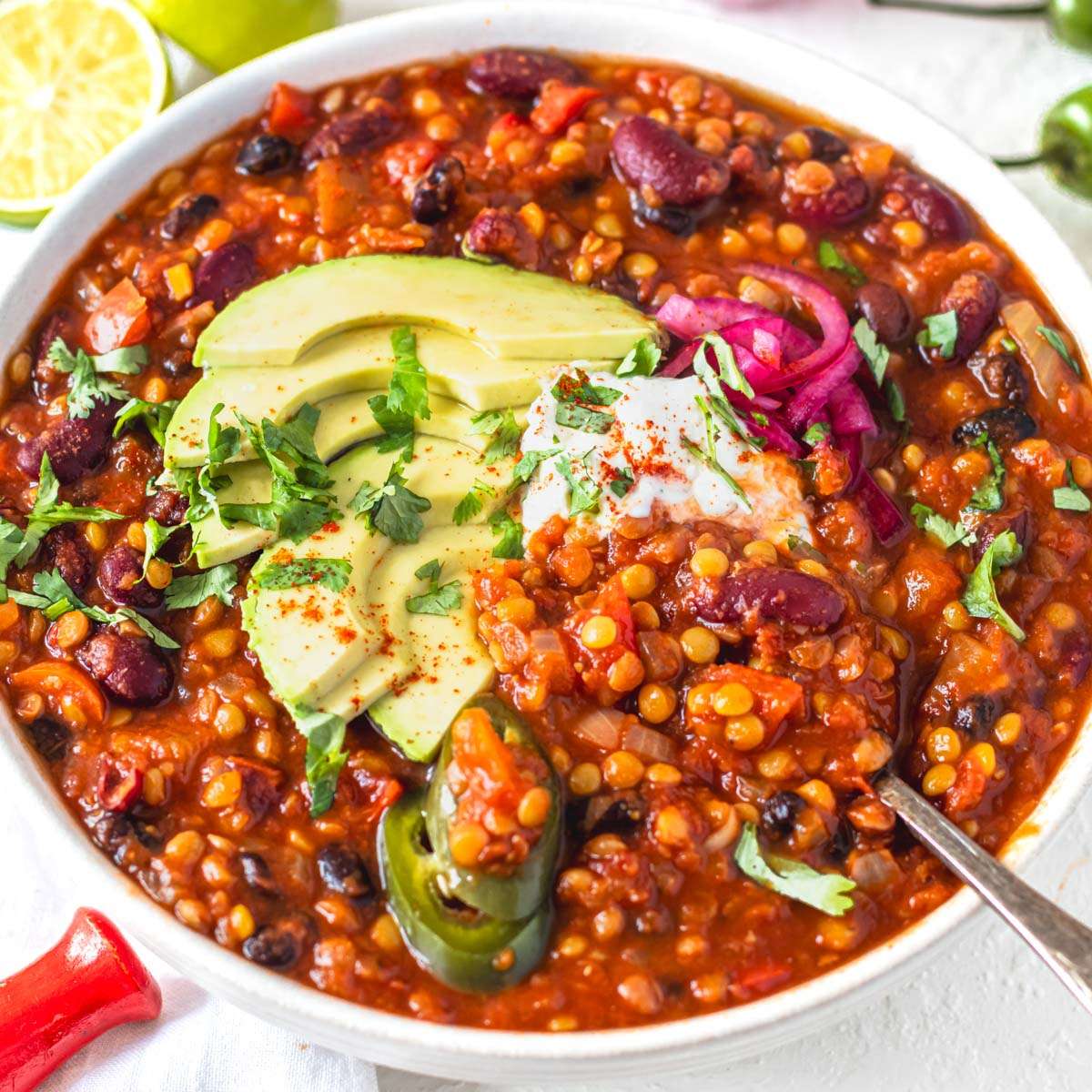 Lentil chili topped with avocado and sour cream.