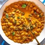 Marry me butter beans in a blue skillet.