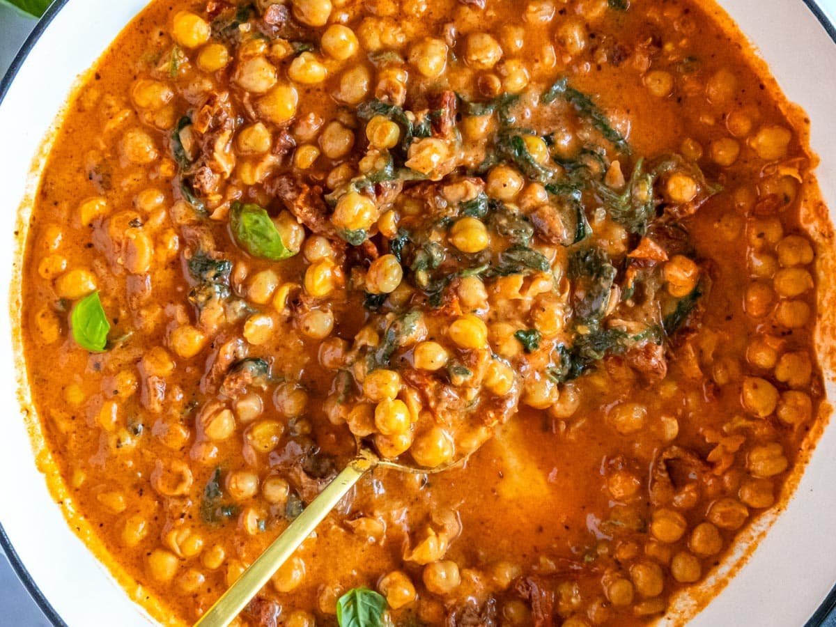 Marry me chickpeas in a white skillet.