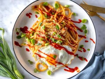 Miso pasta with sriracha sauce and a fried egg.