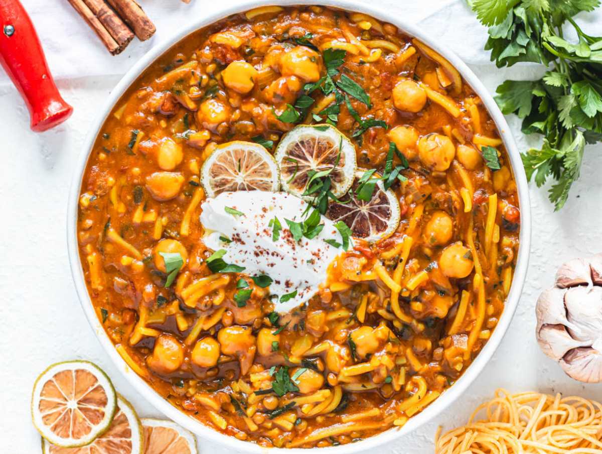Moroccan harira in a bowl with a dollop of yogurt and parsley.