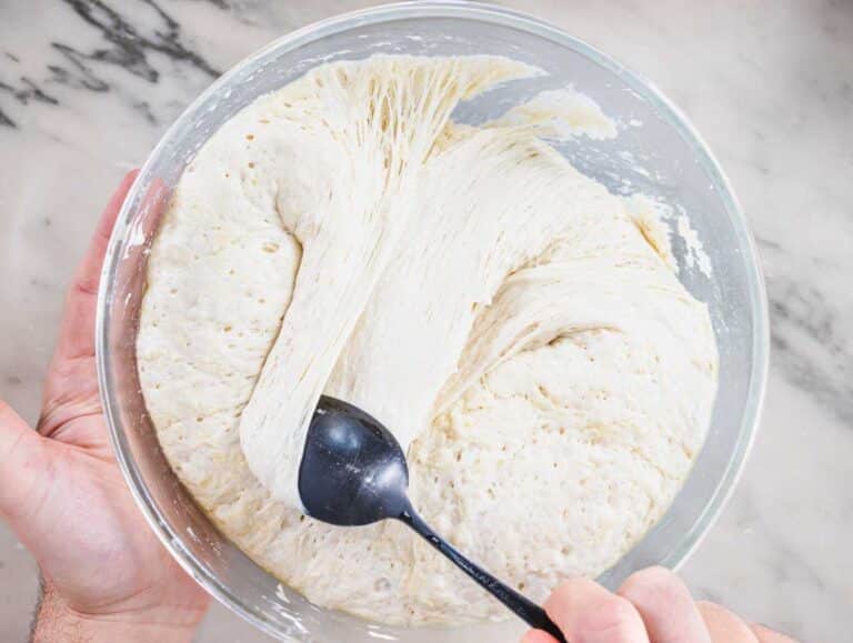 Nico folding the dough in the bowl.