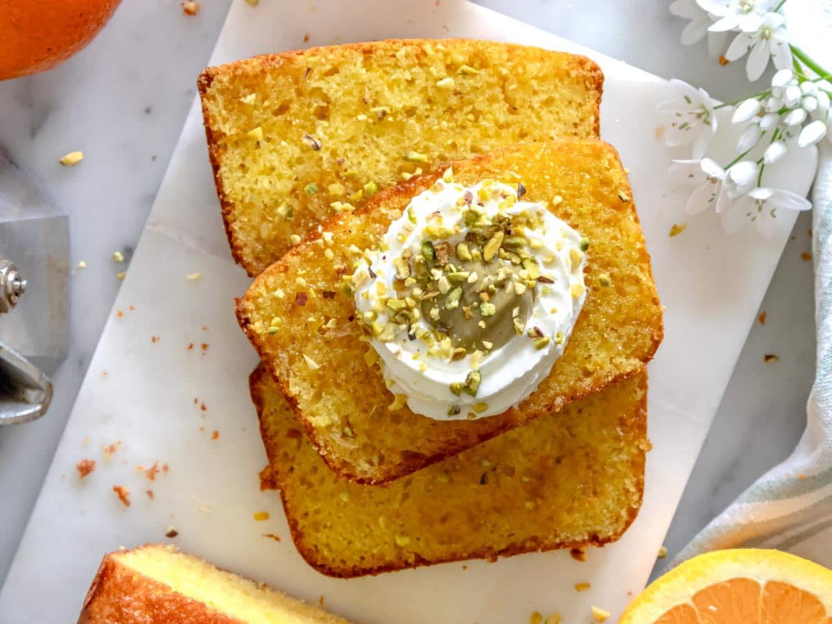 Orange cake with pistachio butter and whipped cream.