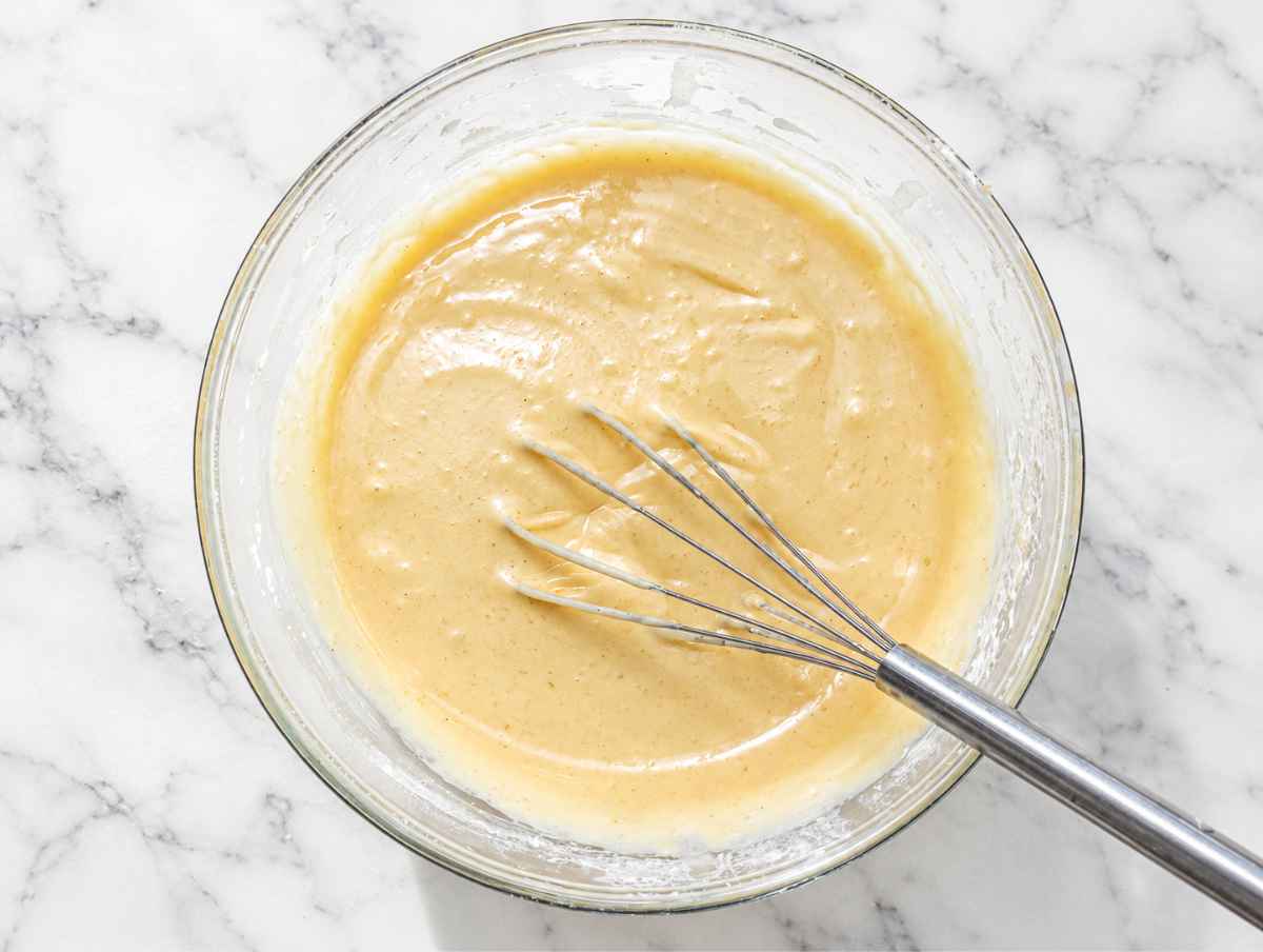 Step 1 Wet ingredients whisked with flour and baking powder for apple cake batter.