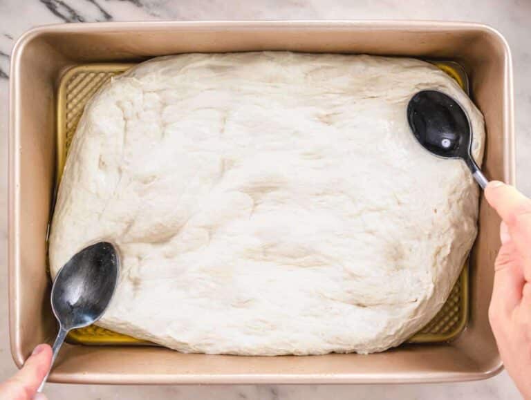Step 5 Focaccia dough spread into oiled baking pan before second rise.