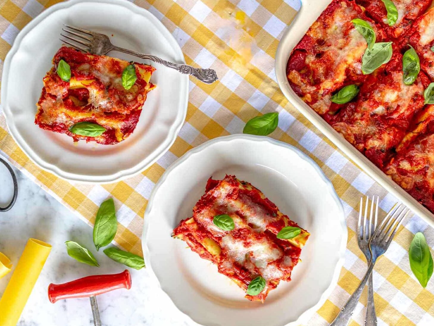 cannelloni (manicotti) in a casserole dish and on two plates