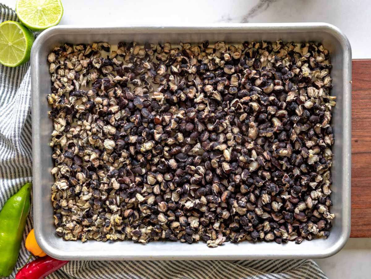 Black beans dried in the oven on a baking tray.