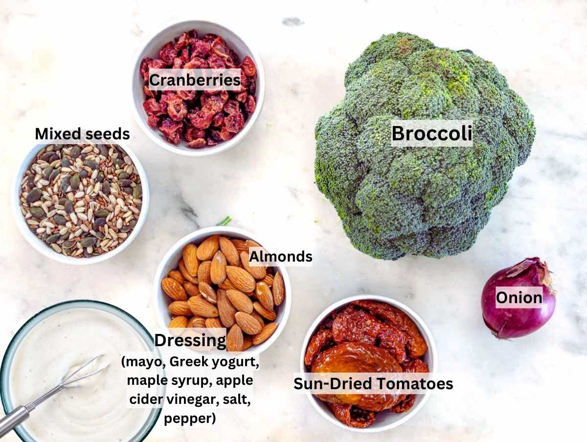 Ingredients for broccoli salad on a marble table.