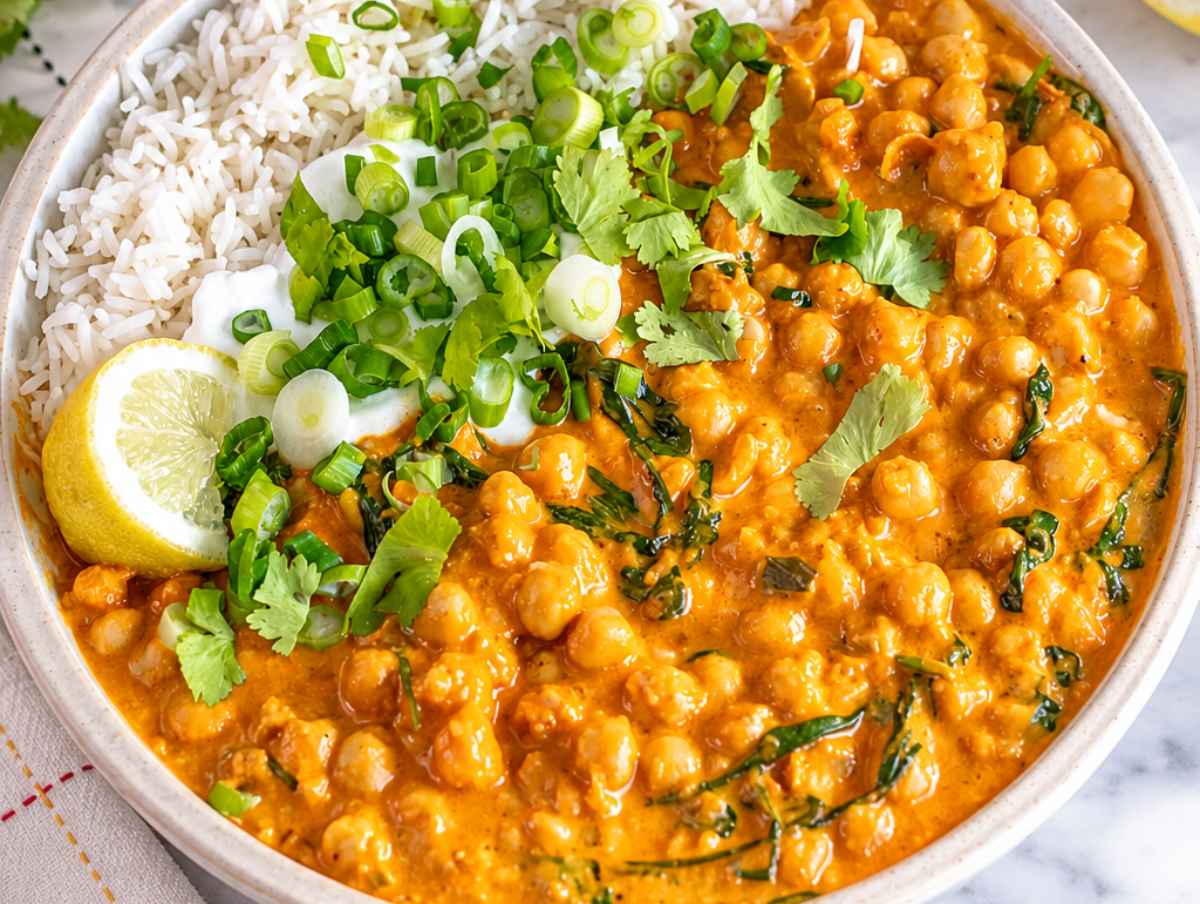 Step 4 Chickpea curry spooned over basmati rice with cilantro, lemon, and yogurt.