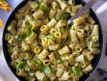 Zucchini pasta topped with lemon zest and basil pesto.