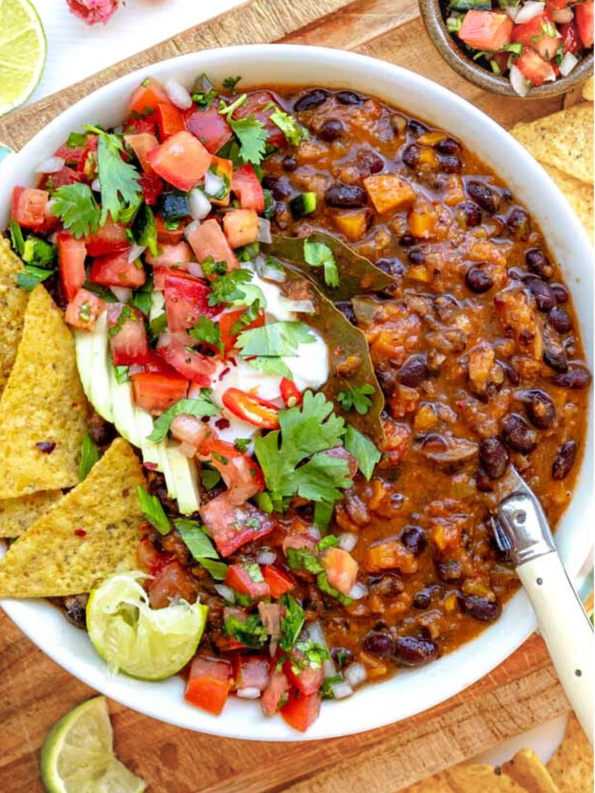Black bean soup topped with sour cream and pico de gallo