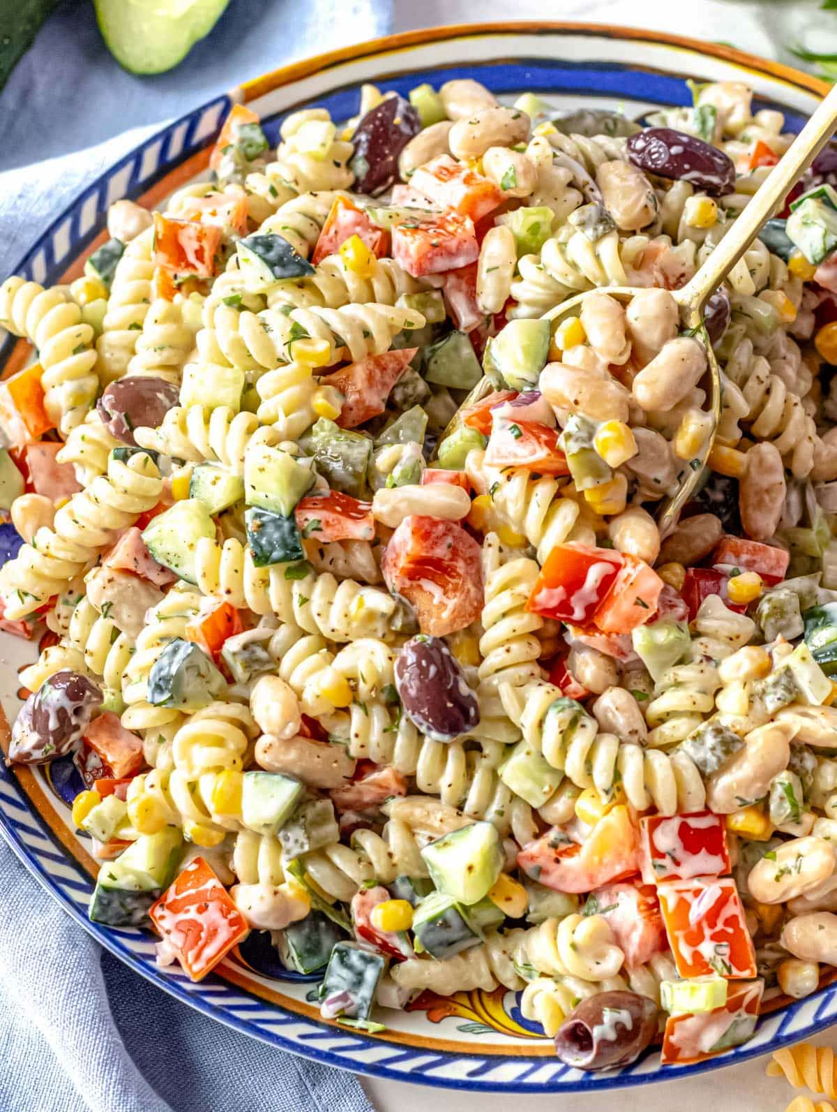 Creamy pasta salad on a blue platter.
