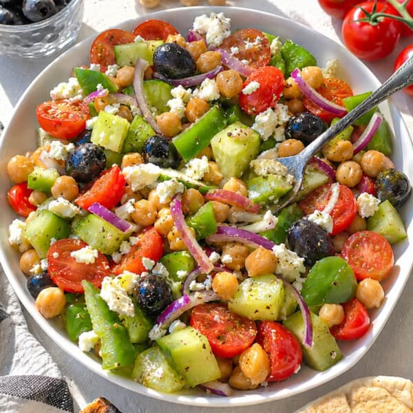 Greek chickpea salad with a rustic silver fork.