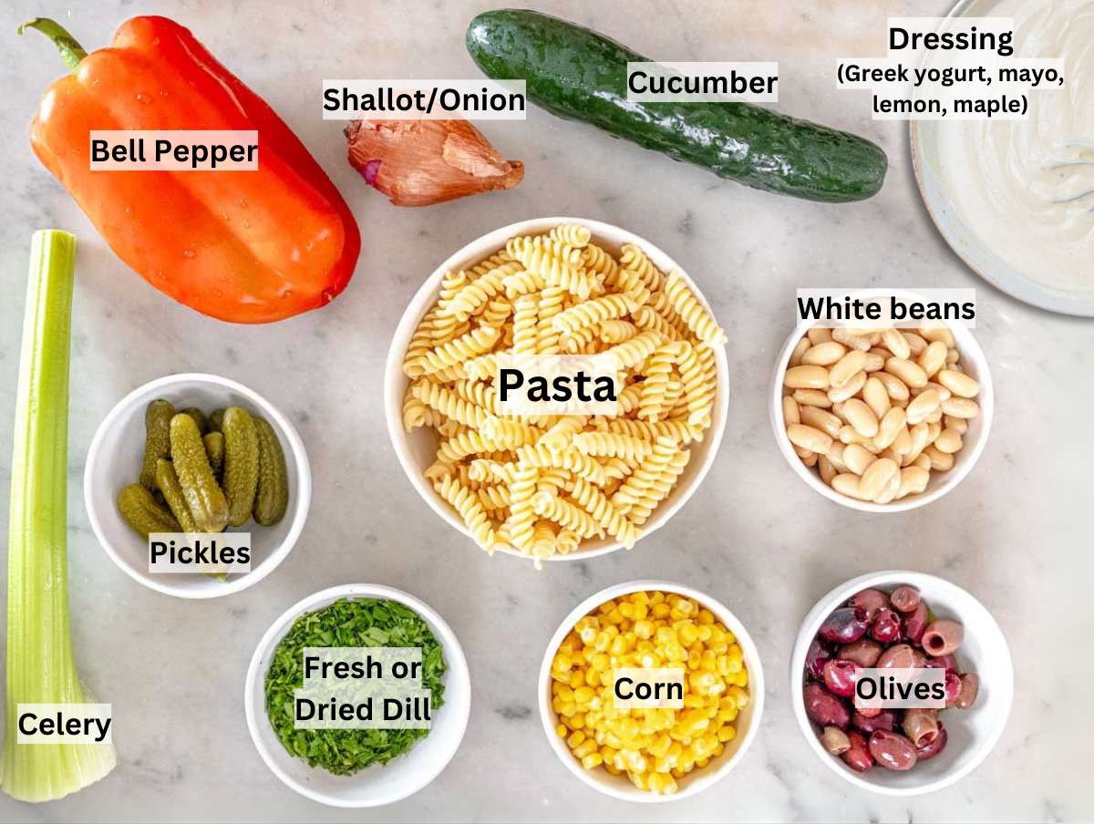 Ingredients for creamy pasta salad on a marble table