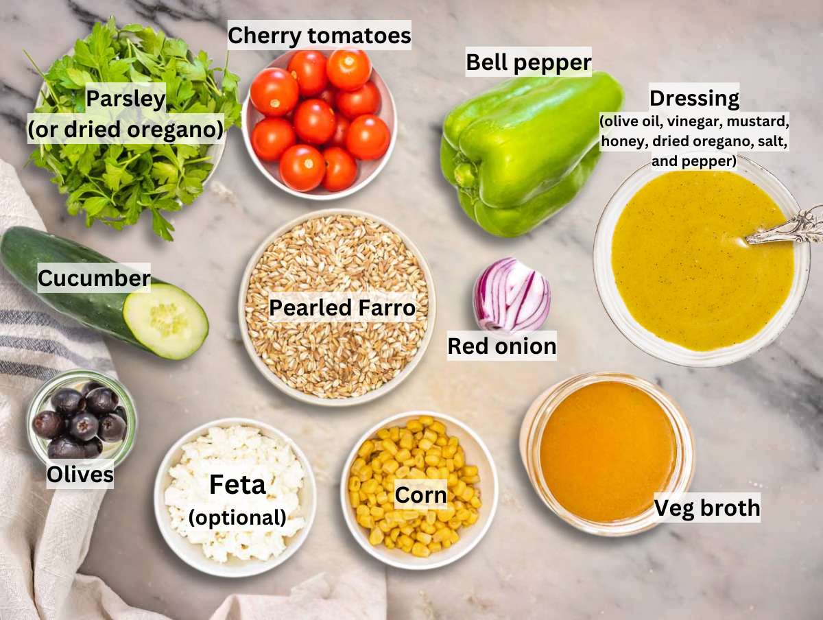 Ingredients for farro salad on a marble table.