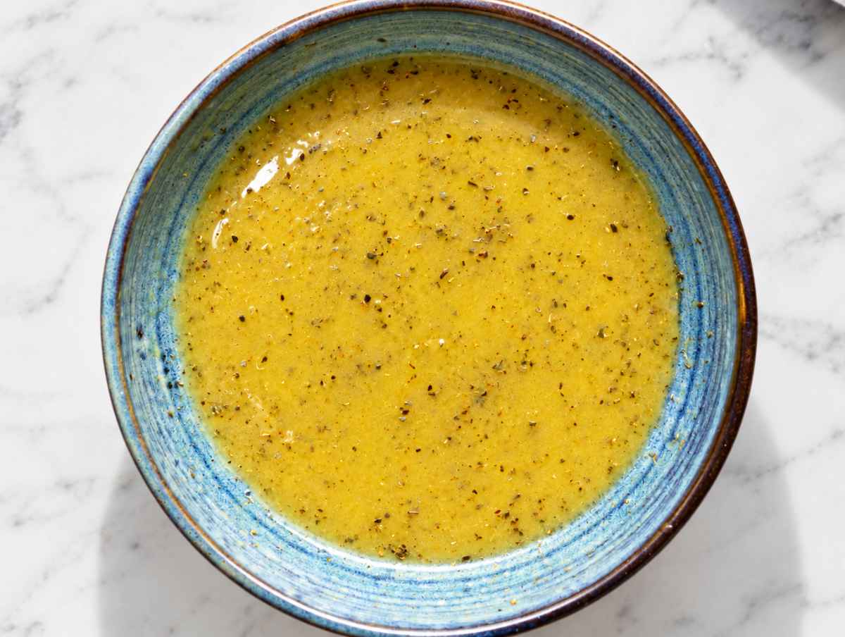 Step 1 Olive oil, vinegar, mustard, maple syrup, and oregano whisked together.