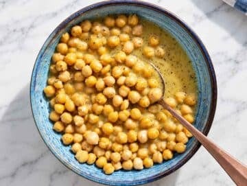 Step 2 Chickpeas tossed with Greek dressing until glossy and evenly coated.