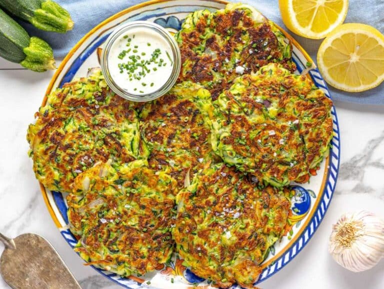 Step 5 Serving the zucchini fritters on a platter with fresh lemon.
