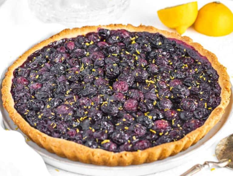 Baked blueberry tart with lemon zest on top.