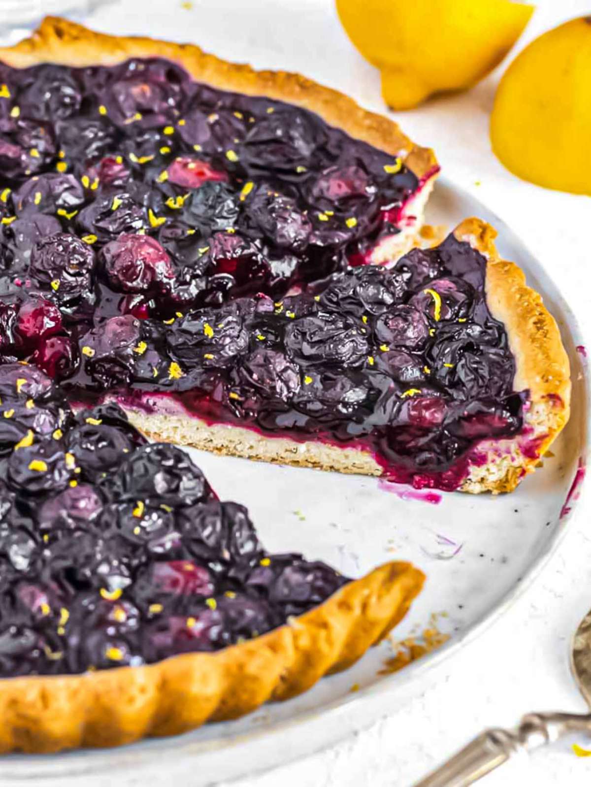 Blueberry tart sliced with jammy blueberry filling.