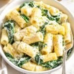 Bowl of lemon ricotta pasta on white Carrara marble in daylight.