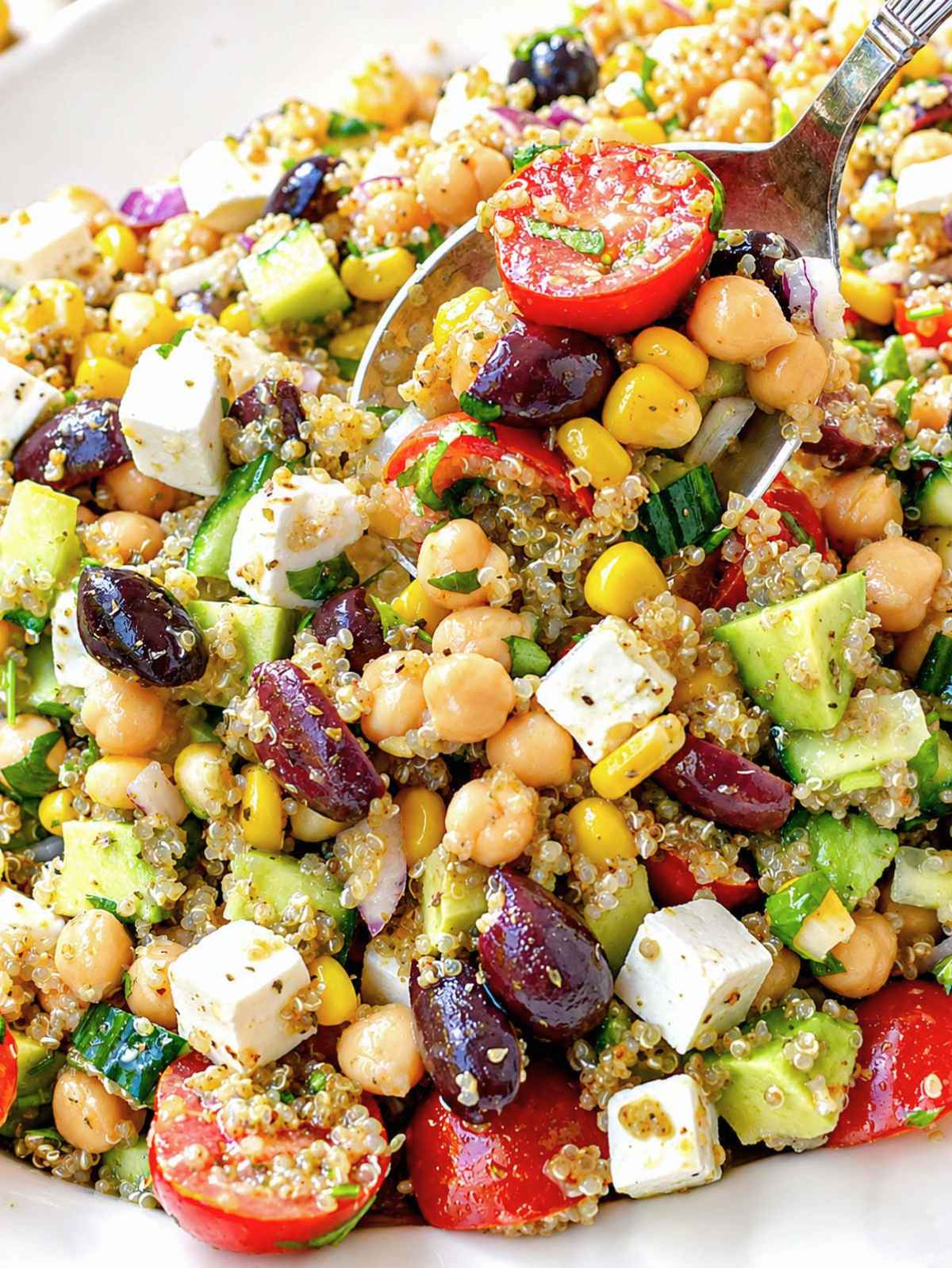 Close-up of quinoa chickpea salad with creamy feta and avocado.