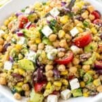 Colorful quinoa chickpea salad served in a large white bowl