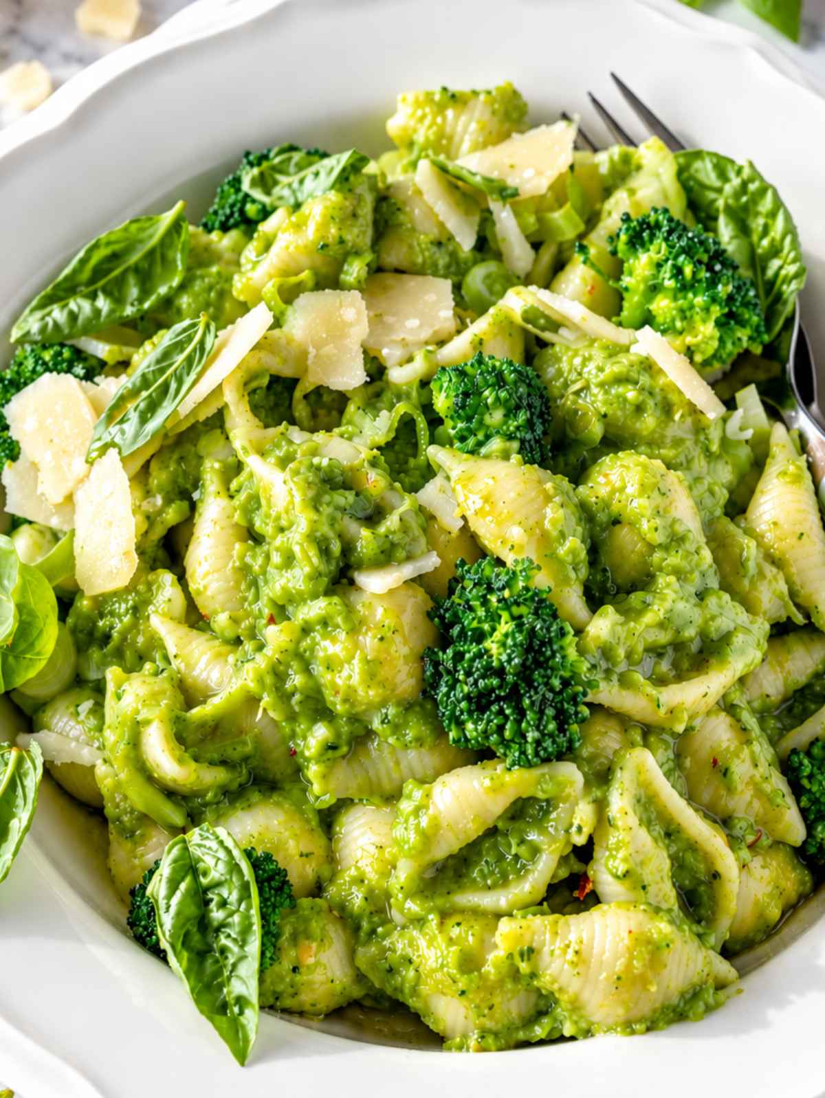 Creamy broccoli pasta coated in glossy green sauce with grated Parmesan.