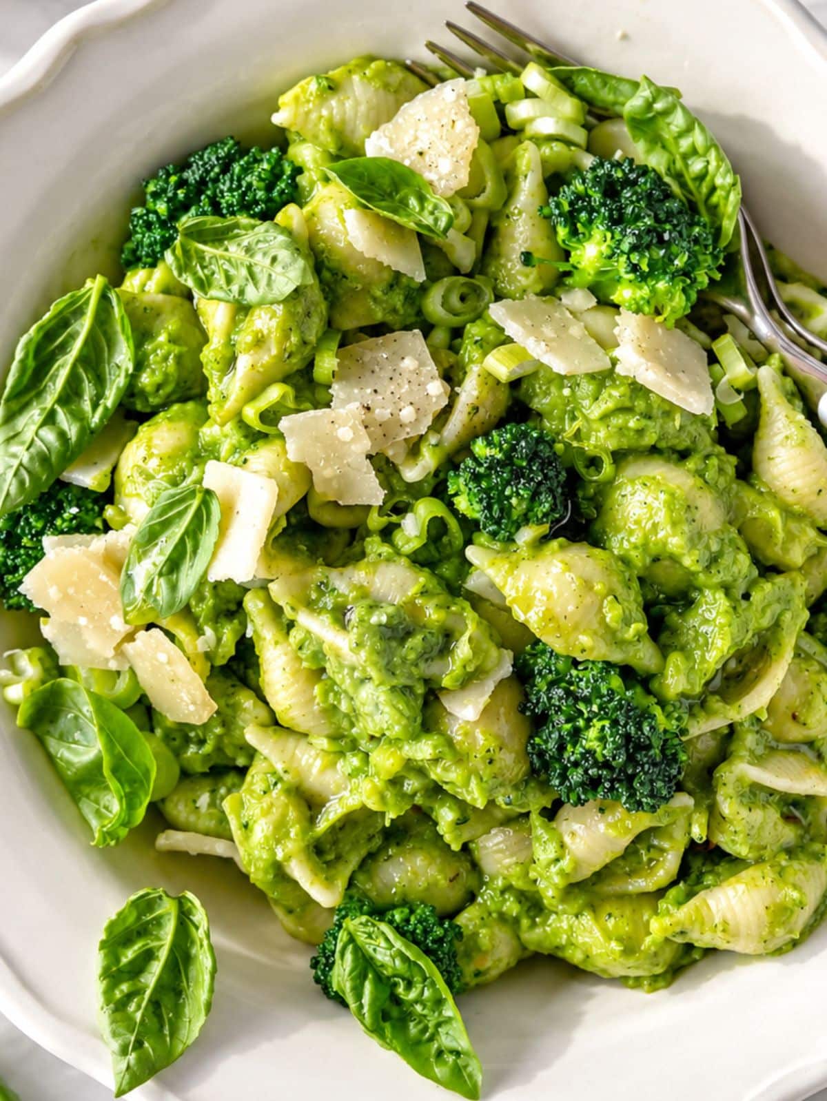 Flat lay of broccoli pasta with creamy sauce, tender florets, and Parmesan.