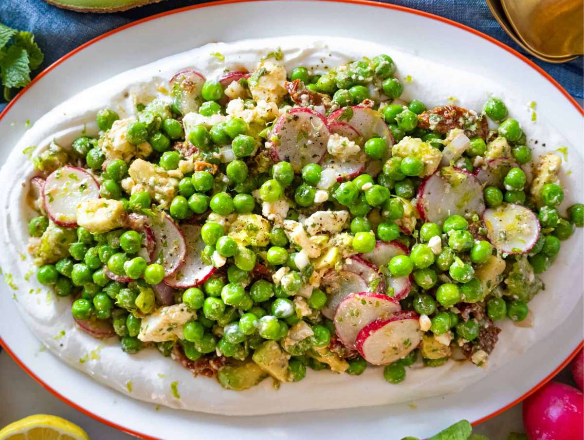 Fresh pea salad recipe served on a platter with Labneh.