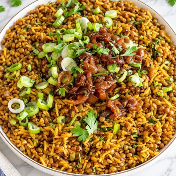 Glossy mujadara with caramelized onions, parsley, and scallions.